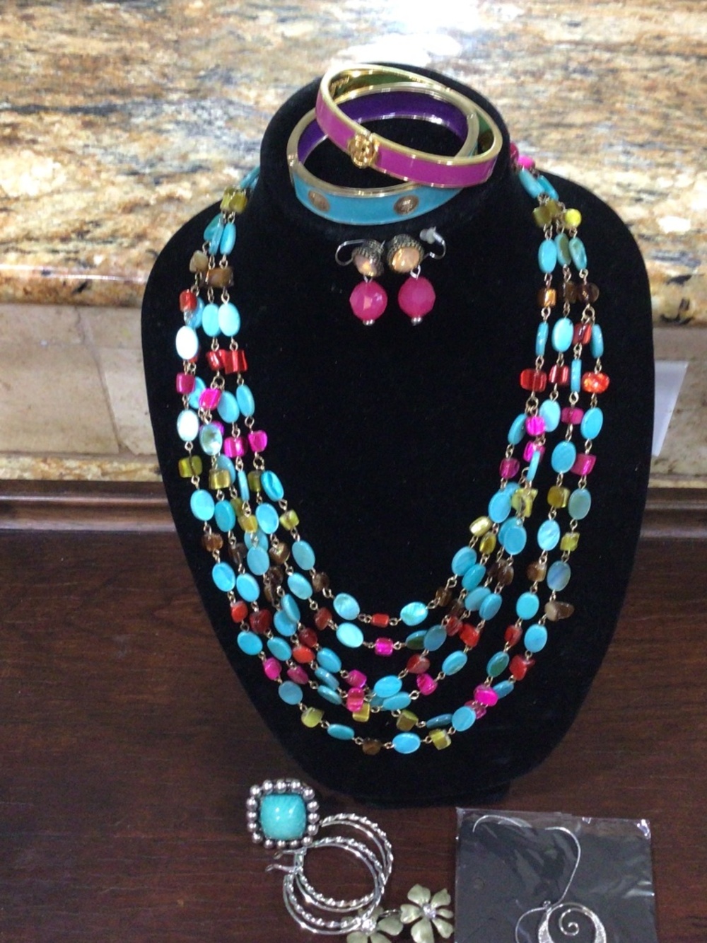 Tray of miscellaneous jewelry. Contains necklace, bracelets earrings, and ring.